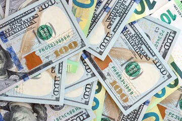 Big pile of Euro and USD banknotes. Many european and united states dollars
