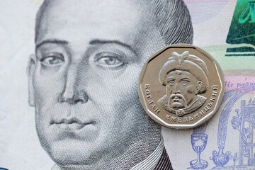 Ukrainian silver coin lies on five hundred hryvnia bill. Financial and business concept. Modern...