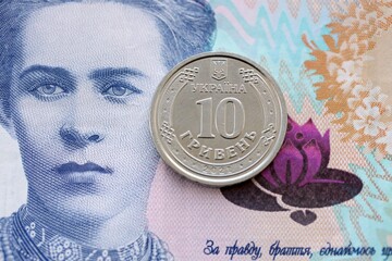 Ukrainian silver coin lies on two hundred hryvnia bill. Financial and business concept. Modern...
