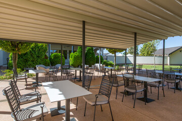 Outdoor restaurant terrace with empty tables