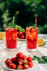 Amazing iced strawberry lemonade drinks. Still life, mojito cocktails for two.