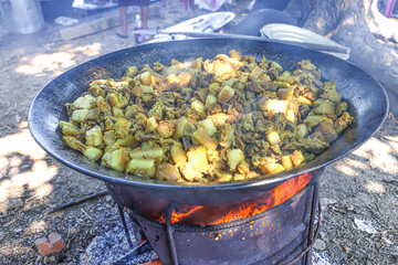 A large dark metal pan was filled with pork.