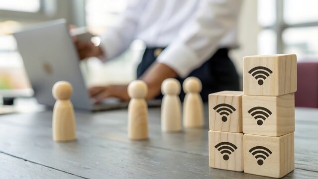 Wooden figures spaced across cube blocks with Wi-Fi icons — remote team management concept
