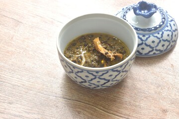 boiled Cassia tree leaf or Thai copper pod with grilled mackerel fish in coconut milk and curry...