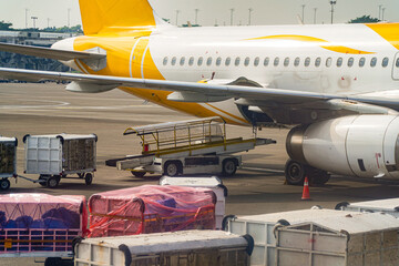 A passenger aircraft stands ready, its turbine engines and baggage carts poised for action,...