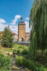View of the town tower of Bad Staffelstein in Upper Franconia with the Lauterbach stream in the...