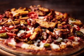 Gyros Pizza with jalapeno pepper, cherry tomatoes and mozzarella cheese. Soft focus. Close up.	