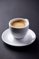 Cup of coffee on paper background. Close up. Copy space.