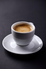 Cup of coffee on paper background. Close up. Copy space.