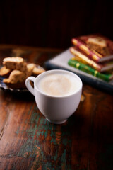 Cappuccino on dark wooden background. Soft focus. Close up.	