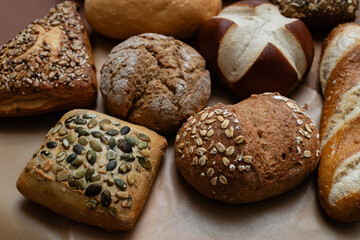 Various types of crusty German breads and flaky pastries offer a delicious spread, perfect for a breakfast or brunch setting