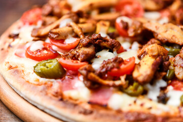 Gyros Pizza with jalapeno pepper, cherry tomatoes and mozzarella cheese. Soft focus. Close up.