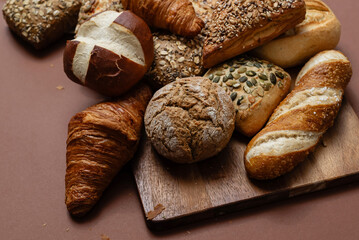 Various types of crusty German breads and flaky pastries offer a delicious spread, perfect for a breakfast or brunch setting