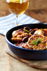 Grilled chicken pieces with kalamata olives and fresh rosemary. Close up.