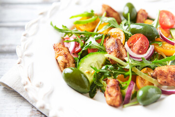 Healthy Salad with Chicken Breast, Cherry Tomatoes, Cucumber, Rocket and Green Olives. Close up.