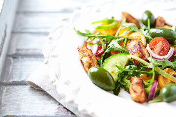 Healthy Salad with Chicken Breast, Cherry Tomatoes, Cucumber, Rocket and Green Olives. Close up.