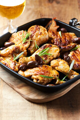 Grilled chicken pieces with kalamata olives and fresh rosemary. Close up.