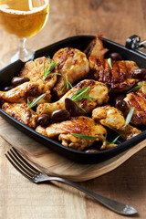 Grilled chicken pieces with kalamata olives and fresh rosemary. Close up.