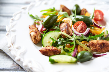 Healthy Salad with Chicken Breast, Cherry Tomatoes, Cucumber, Rocket and Green Olives. Close up.