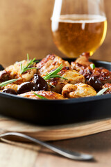 Grilled chicken pieces with kalamata olives and fresh rosemary. Close up.