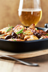 Grilled chicken pieces with kalamata olives and fresh rosemary. Close up.