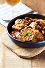 Grilled chicken pieces with kalamata olives and fresh rosemary. Close up.