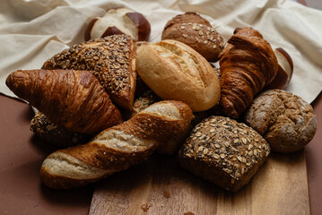 Various types of crusty German breads and flaky pastries offer a delicious spread, perfect for a breakfast or brunch setting