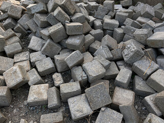 Pile of left over pavers, flooring or concrete block paving, cube shape
