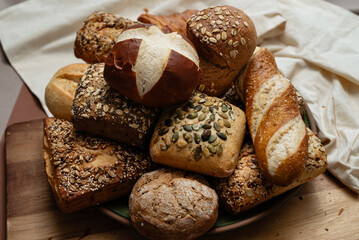 Various types of crusty German breads and flaky pastries offer a delicious spread, perfect for a...