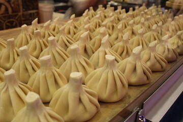 Raw khinkali on the blackboard, medium plan. Preparation of national food