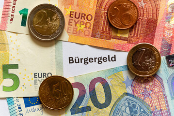 The word "Bürgergeld" on a white background, new financial aid system in case of long-term unemployment in Germany. Bürgergeld means citizens money.