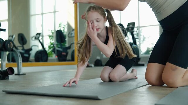 young girl is practicing a bridge pose in gymnastics.	
