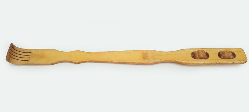 A wooden back scratcher on a white background, a hand shaped itch relief tool with long handle