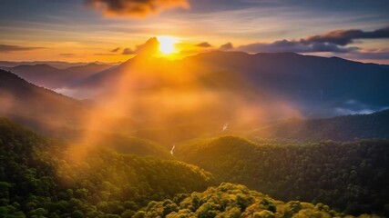 Timelapse of golden sunrise rays slowly creeping over tropical mountain ridge, illuminating lush green valleys. - Powered by Adobe