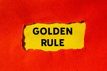 Golden rule message written on ripped torn red paper on yellow background. Conceptual golden rule...