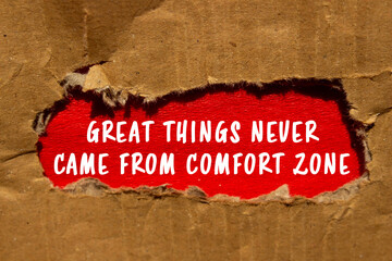 Great Things Never Came From Comfort Zone message written on ripped torn cardboard paper red...