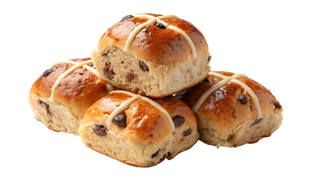 A pile of freshly baked sweet hot cross buns with dried fruit and a white cross on top against a black background