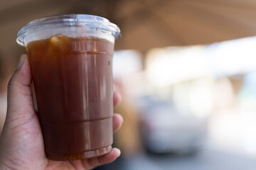 Close up of take away plastic cup of iced black coffee or Americano.