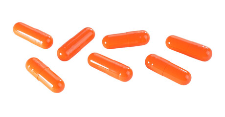 Bulk orange capsule pills isolated on white background.