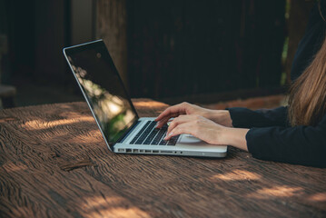 Happiness Asian Woman working from home using laptop online meeting in home office. Happy relax...