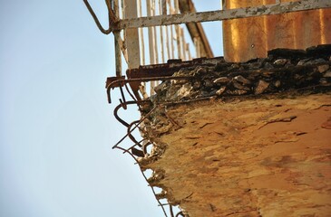 damaged building balcony. danger from a damaged old building