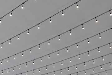 Decorative string lights illuminate a venue for an event celebration
