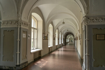 Fototapeta premium Old gothic building. Arched Hallway With Vaulted Ceiling Interior University. Empty school