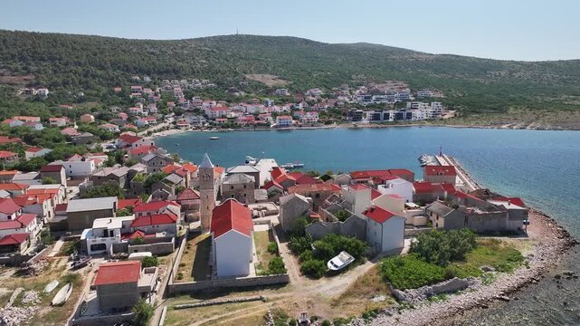 Top down drone video showing boats moored in Vinjerac marina along the scenic shoreline