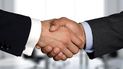 A handshake between two people in suits symbolizing an agreement or partnership