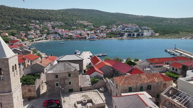 Drone video capturing Vinjerac with a winding coastal road and stone houses by the sea