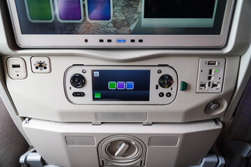 Aircraft entertainment system featuring a control panel, USB port, and power outlet, providing...
