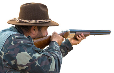 Hunter man in camouflage with a gun during the hunt in search of wild birds or game.