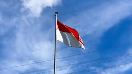 Indonesian Flag, The Red and white Flag, national symbol of Indonesia on the top. isolated blue sky background. Good structure for using background needed or independence day