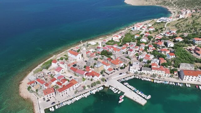 Wide aerial view of Vinjerac village by the sea with the Velebit mountains in the background
